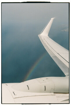 Airplane Wing with Rainbow Seen from Window Mid-Flight