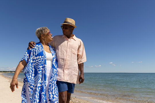 Senior Black Couple walk beach fun 