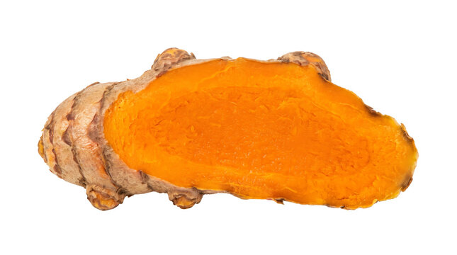 Fresh turmeric root sliced in half to show vibrant orange interior