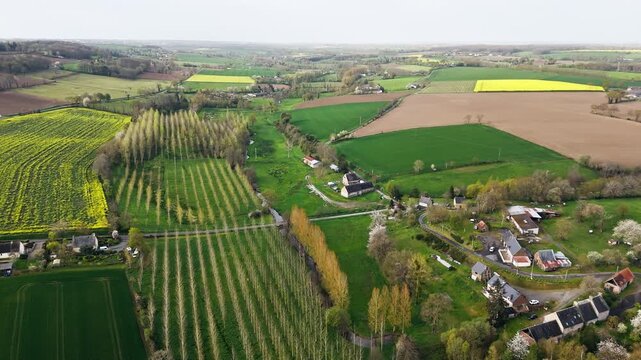 Aerial of French countryside in Normandy with farmland, small settlements and green rural scenery