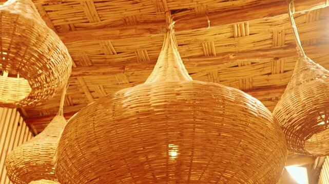 Warm Rattan Pendant Lamps and Woven Bamboo Ceiling in Rustic Tropical Hut Interior