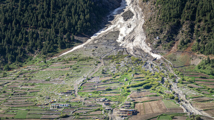 Naklejka premium Avalanche and landslide debris flow path descending into Zanskar valley terraced village fields in Ladakh