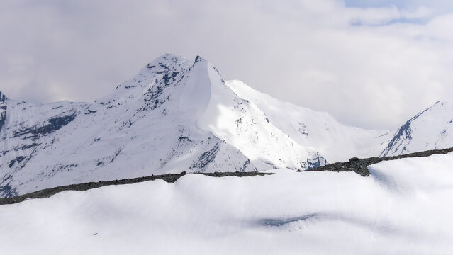 Snow-Covered Himalayan Mountain Peak in a Pristine Winter Landscape Under a Cloudy Sky
