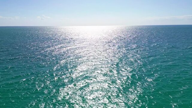 Turquoise water ocean waves. Drone overhead coastal beach. Sand shoreline foam texture. Holiday seascape summer background.