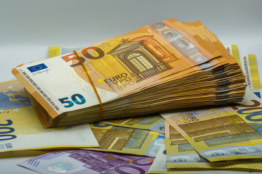 Bundle of Euro bills, close-up of fifty euro banknotes stacked with elastic band, finance concept