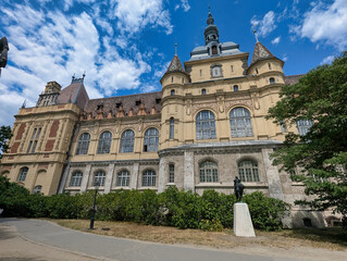 Fototapeta premium Main façade of Vajdahunyad Castle with towers, decorative stonework and historic architecture in City Park, Budapest, Hungary.