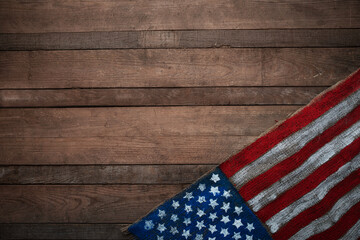 Obraz premium USA flag on burlap fabric over wooden wall background, rustic patriotic texture with copy space for national holidays, Independence, Flag and Constitution Day design.