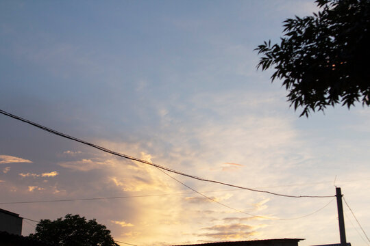 Sunset Sky Over Rural Moldova with Utility Wires and Silhouetted Trees