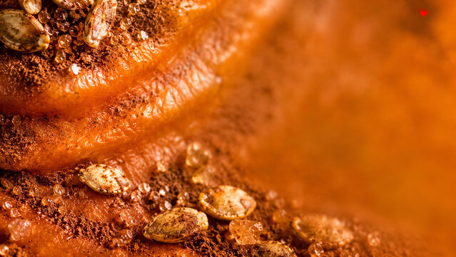 Halloween Macro Food Background with Pumpkin Skin, Cinnamon, Roasted Seeds and Sugar Crystals
