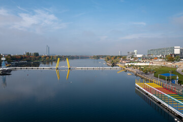 A view of the New Danube River in Vienna, Austria. In the center, the Ponte Cagrana pedestrian pontoon bridge is visible. On the right is the CopaBeach recreation area. © Arkadii