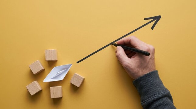 Hand drawing upward arrow with paper boat and wooden blocks, business success concept