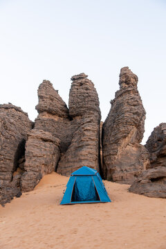 Blue Tent Pitched Among Rock Pinnacles at Dusk