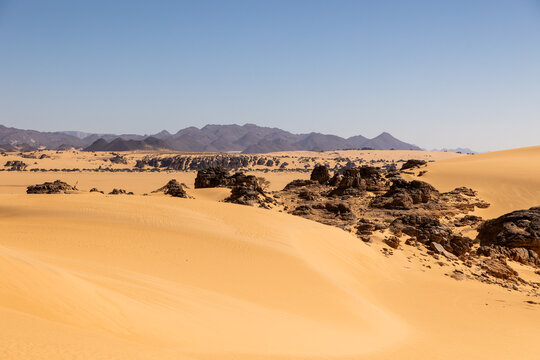 Sand Dune With Distant Rock Formation