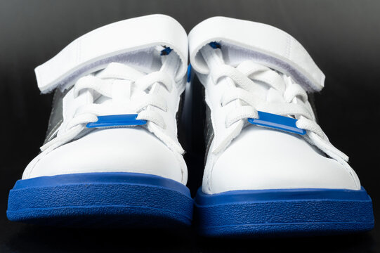 White sport shoes with blue sole