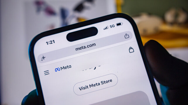 Close up view of smartphone displaying meta store visit page on mobile browser.