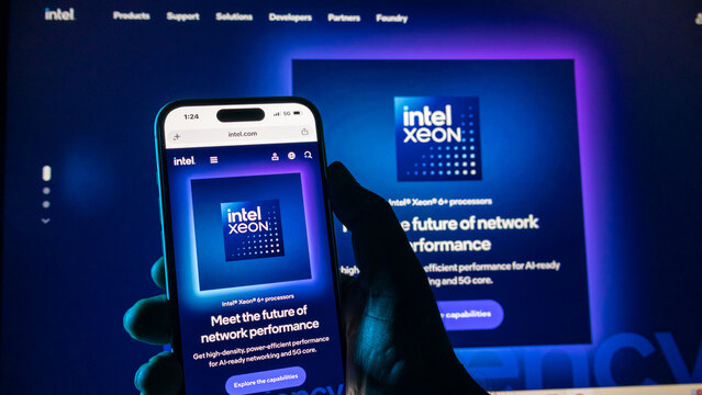 Close up view of intel website on iphone 15 pro max screen, hand holding a smartphone.