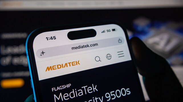 A close up of a hand holding an iphone 14 pro displaying mediatek.com website on its screen.