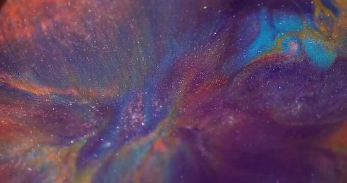 Shimmering spill blur. Ink blend. Purple blue pigment fluid swirling on glitter particles colorful texture on abstract background.