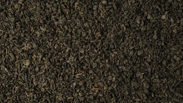 Dry green tea leaves background texture