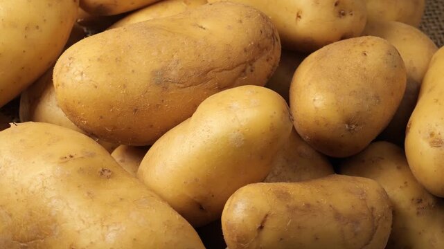 Raw whole potatoes rotating