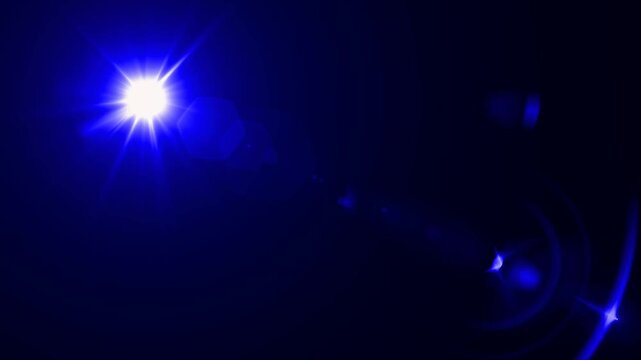 abstract light rays emanating from a center light source over a starry ,optical lens flare shine light animation on black background. Explosion lights optical flare transition, light moving 
