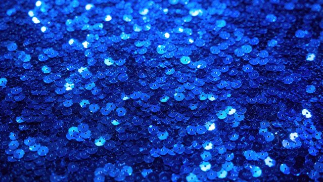 Close-up of blue sequin fabric with shimmering glittery bokeh and reflective sparkle texture