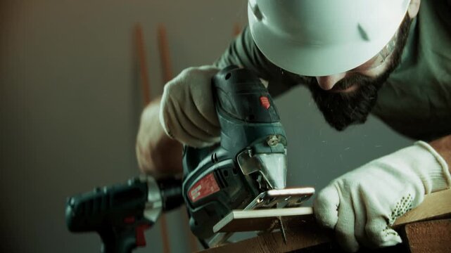 Carpenter Cutting Wooden Plank With Electric Jigsaw Power Tool. Woodworking Process