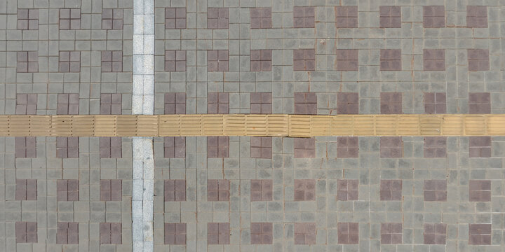 top view of surface of pedestrian path with paving slabs with the border of light and shadow