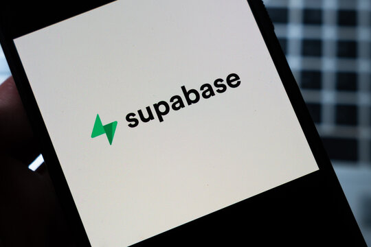 Warsaw, Poland - July 26, 2026: Supabase logo displayed on smartphone screen held in hand against dark blurred background, showing green lightning bolt icon