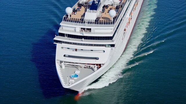 Cruise liner underway in calm water. Aerial footage for travel deal, cruise package and summer vacation planning