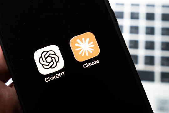 Warsaw, Poland - July 26, 2026: ChatGPT and Claude AI assistant apps displayed side by side on smartphone screen showing competition between AI chatbot platforms