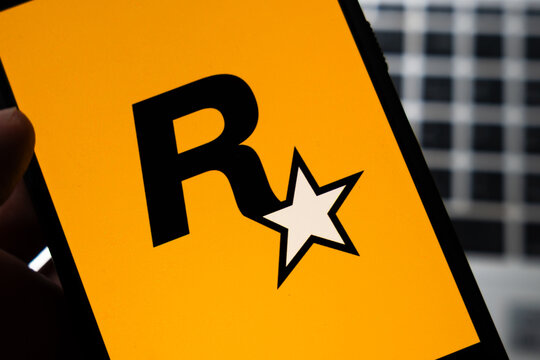 Warsaw, Poland - July 26, 2026: Rockstar Games logo displayed on smartphone screen held in hand against blurred building background in close-up view