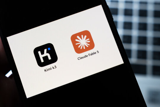Warsaw, Poland - July 26, 2026: Kimi k3 and Claude Fable 5 AI assistant app icons displayed side by side on smartphone screen against white background