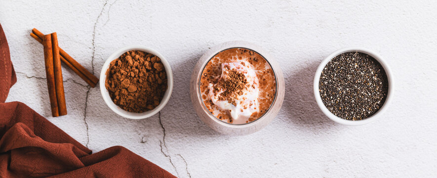 Healthy breakfast overnight oats and chia in a glass on the table top view web banner