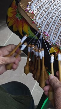 Bobbin lace. A traditional lacemaker creates lace using a traditional process introduced by Azorean settlers; a handicraft available for sale in the historic center of Florianópolis vertical 4k