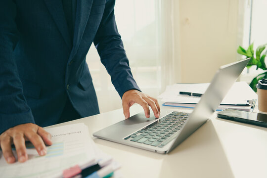 Financial reporting workflow with business professional using laptop and organised documents to review performance manage records improve efficiency and support informed strategic decisions.
