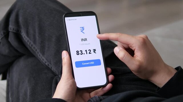 User checks a live USD to INR exchange rate on a smartphone, reflecting global currency movements, digital finance growth and the rising demand for instant international money conversion.