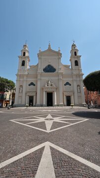 Pietra ligure, liguria, italy. June 24, 2025. Majestic facade of the basilica of san nicolo, a historic catholic church in pietra ligure, liguria, italy, on a sunny summer day