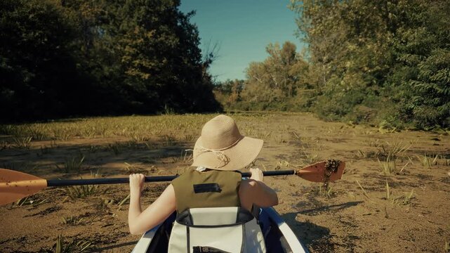 Woman Paddling Kayak Boat On Calm River Surface Through Water Plants. Outdoor Adventure Leisure Active 