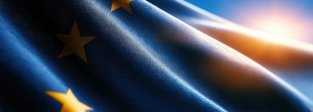 Waving flag of the European Union under a clear sky during sunset