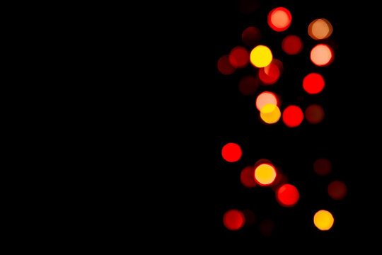 Festive background with colorful bokeh on black background, copy background