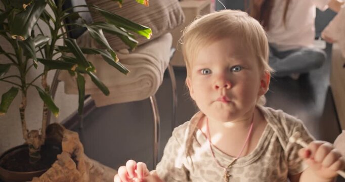 Toddler walking toward the camera during a first steps milestone at home. Independent movement and early childhood development
