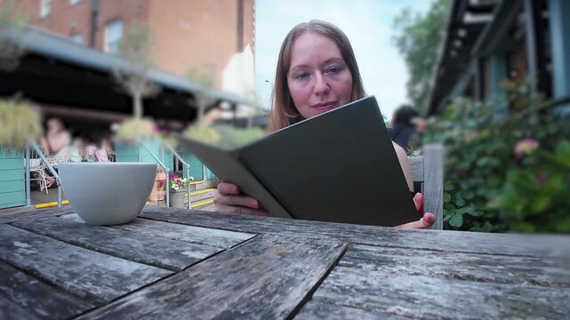 Woman looking at a menu in a pub