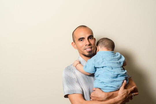 Father holding child lovingly expressing parenthood bond