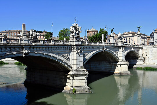 panoramic view of the Ponte Vittorio Emanuele II in Rome, Italy over the Tiber river. Landmark. Triple-arched Roman bridge. large winged stone sculptures. travel and tourism concept.