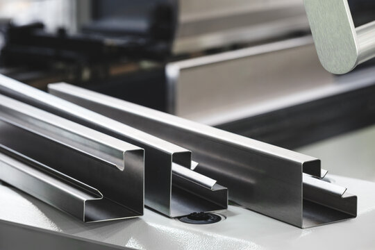 Industrial concept. sheet metal detail manufactured using an industrial bending machine. tech industrial technology background