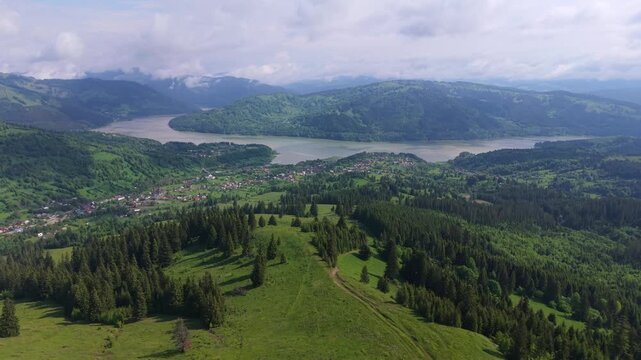 Aerial view showing the stunning landscape of Lake Bicaz, also known as Izvorul Muntelui, in Romania surrounded by lush green forests and hills