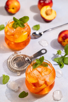 Refreshing iced peach tea cocktails with mint garnish