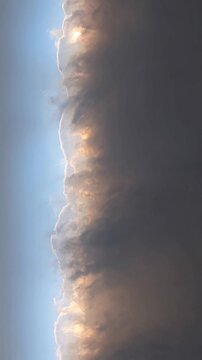 Turbulent storm cloud with silver lining growing in the blue sky, capturing the dramatic beauty of meteorology, weather patterns, and the powerful forces of nature