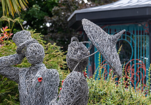 A selective-focus shot of Saltburn&rsquo;s wire sculpture group, with sharp detail on the lady figure, set against softly blurred surrounding forms and backdrop.